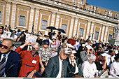 Attending a mass with the Pope under bright sun. St. Peter square. Vatican. Rome. Italy.