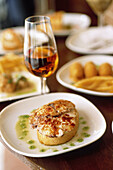 Spain. Andalusia. Jerez. Local cooking tapas, octopus and old Sherry Amontillado at the restaurant Gallo Azul