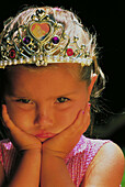 Unhappy young girl dressed up as a princess