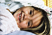 Girl smiling in bed