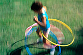 Girl playing with hula hoops