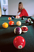 Young lady playing billiards