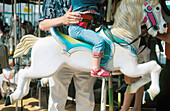 Child with parent at carousel