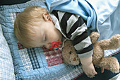 baby sleeping with teddy bear