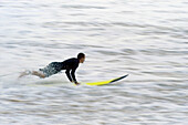 Surfer goint into the water