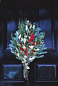 holiday plant decorations hanging on a door