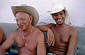 Young and senior farmers smoking cigar. Trinidad. Cuba
