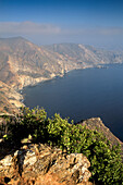 Steep rugged hills, coastal cliffs, and blue Pacific Ocean water, near Two Harbors. Catalina Island. California. USA