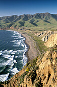 Green hills in spring and coastal waves breaking on sand shore of Christy Beach. Santa Cruz Island. Channel Islands Natinal Park. California. USA