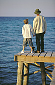 ian, Caucasians, Child, Children, Color, Colour, Contemporary, Dad, Daytime, Dock, Docks, Embrace, Embracing, Exterior, Families, Family, Father, Fathers, Full-body, Full-length, Hand holding, Hand-ho