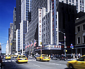 Taxi cabs, Radio city music hall, Sixth Avenue, Manhattan, New York, USA.