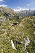 New Zealand, South Island, Fiordland National Park, Waterfall by Lake Norwest - aerial