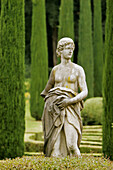 Renaissance marble statue surrounded by cypress trees in the Giardino Giusti, Verona, Italy