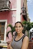 Calle de la Cruz, Hispanic female, architecture. Old San Juan. Puerto Rico.