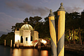 Vizcaya Museum and Gardens, Renaissance Italianate 1910, striped poles, gazebo, dusk. Biscayne Bay. Miami. Florida. USA