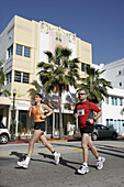 Charity 5K marathon, couple running, jogging, male, female. Ocean Drive. Miami Beach. Florida. USA.