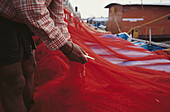 Fishermen fix nets. Kerala. India
