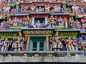 Hindu dieties on tower at entrance to Hindu temple in Bangalore. Karnataka, India 