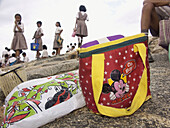 School girls and their lunchbags (with Indian and American icons) at Lal Bagh, a park, in Bangalore, India