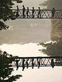 Bridge over a still lake in central Dhaka, Bangladesh