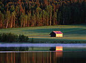 Barn behind lake. Västerbotten. Sweden