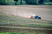 Tractor sow crop on a field. Ragvaldstrask, Västerbotten, Sweden