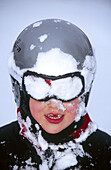 A portrait on a snowy six years old boy, in close up. Medle. Västerbotten, Sweden