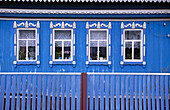 Four windows on a blue russian house. Near Ufa. Bashkortostan. Russia.