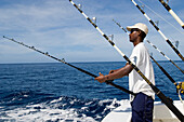Man deep sea fishing on a boat, ship, Mauritius