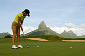 Woman playing golf on a golf course, Tamarin Golf Course, Mauritius, no MR