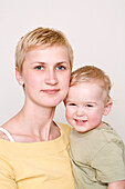 Mother and son smiling at camera, Düsseldorf, North Rhine-Westphalia, Germany