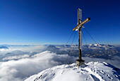 Cross on summit of Naunspitze, view to Bavarian foothills with Wendelstein, fog bank in the valley of river Inn, Naunspitze, Zahmer Kaiser, Kaiser range, Kufstein, Tyrol, Austria