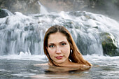 Young Russian woman enjoying hot springs in Yellowstone National Park, Wyoming. USA.