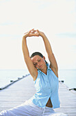 Woman performing yoga in White Sands Resort and Spa. Ari Atoll, Maldives