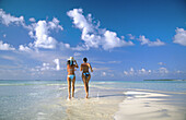 Women on the beach in Ari Atoll. Maldives