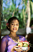 Balinese woman making offers. Ubud, Indonesia