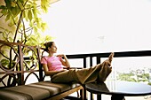 Woman on the balcony. Bangkok. Thailand.