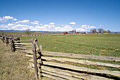 Wooden fence and ranch along the Powder River under the Wallowa Mountains. Eastern Oregon. USA