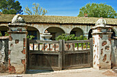 Wooden gates and the courtyard at Mission San Miguel Archangel (16th California Mission - founded 1797)