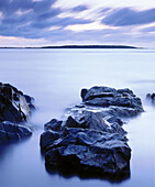 Rocks at water edge overlooking Kattegat sea and Island Hallands Vadero. Bjarne Peninsula. Skane. Sweden