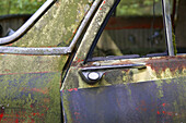Old and rusty junkcars at junkyard in nature. Kyrkömosse, Småland, Sweden, Scandinavia, Europe.
