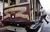 Man and Van Ness Avenue California and Market Streets cable car. San Francisco. California. USA.