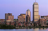 Skyline with Prudential Tower and 111 Huntington Ave building, dusk, Charles River