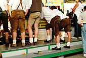 Young Bavarians watching bumper cars at fair. Regensburg. Bavaria, Germany