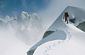 Climber on unnamed peak in winter mist. Fox Glacier. Westland National Park. Southern Alps. New Zealand