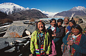 Women and Mani stones in front of Lhagu peaks. Tibet