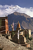 Ancient buddhist monastery and 6000 m. peaks in background. Geling. Kingdom of Mustang. Nepal