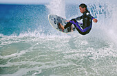 Surfer. Rangi King. Wainui beach. New Zealand.
