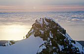 Ski mountaineer. Drummond peak. Sunset over Tasman sea. Westland national park. New Zealand.