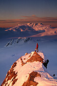 Climber on summit at sunset above Franz Josef Glacier. Westland National Park. New Zealand